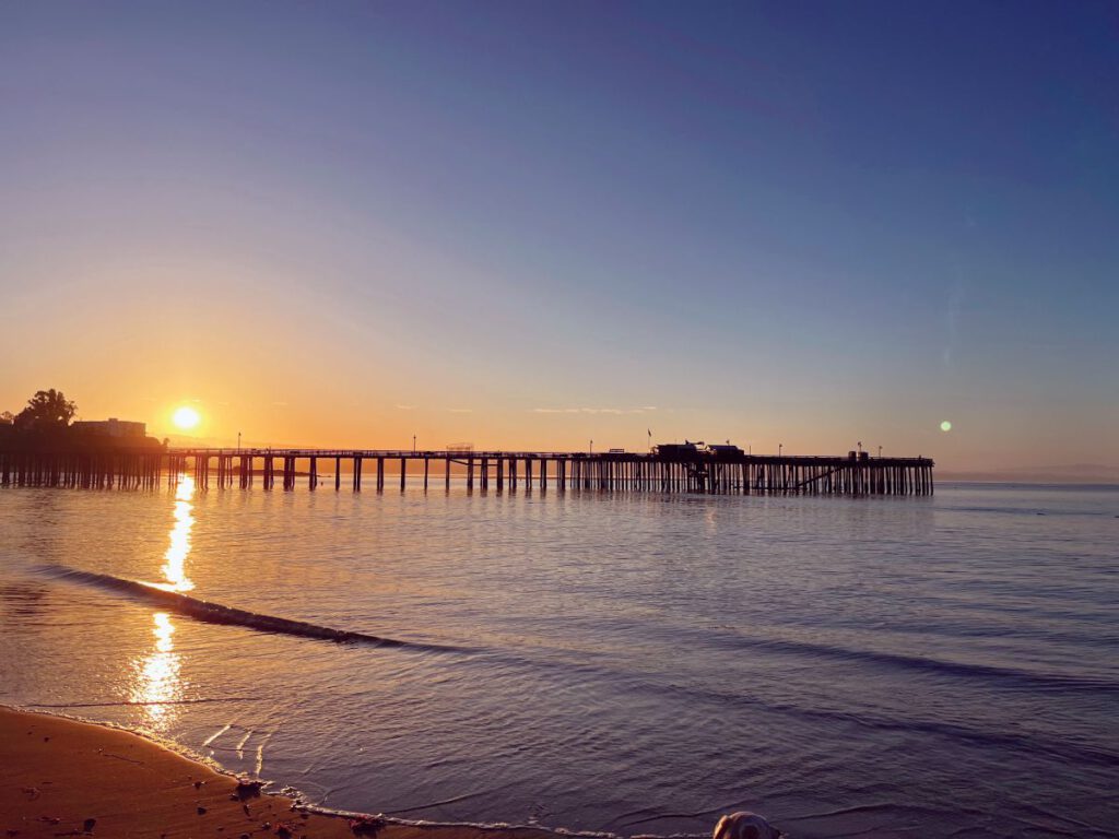 Sunrise over the Capitola Wharf reflected across Monterey Bay