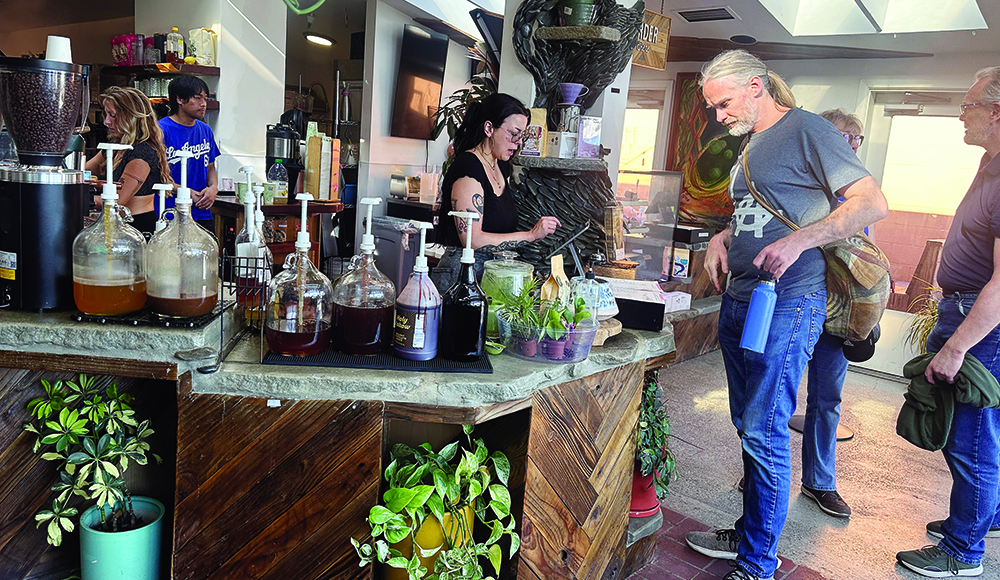 Customers order drinks at the counter inside 11th Hour Coffee in Santa Cruz