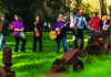Nice Jug Bands The Rivertown Skifflers pose with instruments in a grassy field