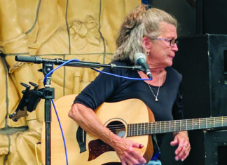 Catalyzing Effect Alabama Annie performs with an acoustic guitar at the Catalyst Atrium in Santa Cruz