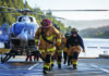 Fighting Fire Zayante volunteer firefighters walk away from a medical helicopter at Loch Lomond