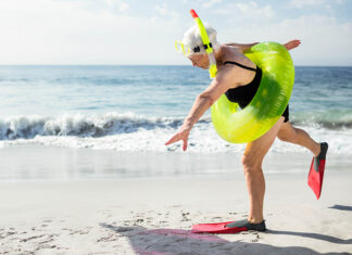 The Aging of Santa Cruz Older swimmer with snorkel and float preparing to enter the ocean