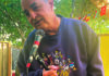 Emerging Talent Kevin Keelan speaking into a microphone at a Seabright garden performance space