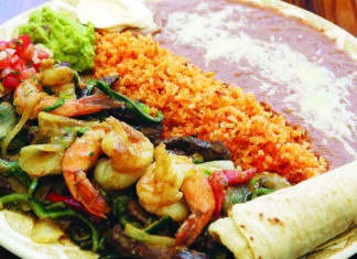 By the Sea Grilled prawns with vegetables, rice, beans, guacamole and tortillas at Dos Pescados