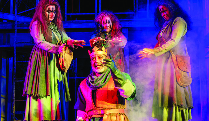 The Editor’s Desk The three witches surround King Duncan in Santa Cruz Shakespeareโs Macbeth