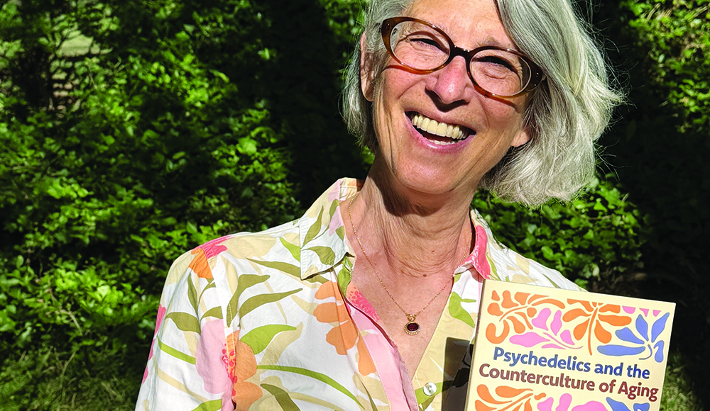 Author Abbie Rosner holds her book Psychedelics and the Counterculture of Aging