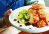 Dining In Brian Grebow of Elite Meal Service holding a plate of Gochujang chicken