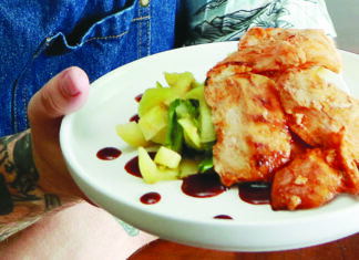 Dining In Brian Grebow of Elite Meal Service holding a plate of Gochujang chicken