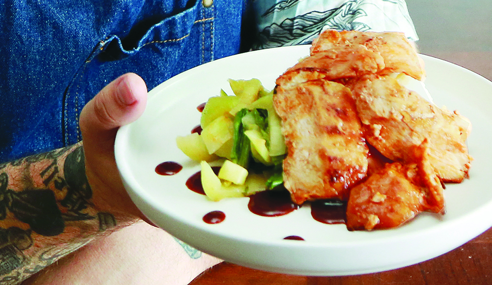 Brian Grebow of Elite Meal Service holding a plate of Gochujang chicken