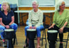 Finding the Groove Three women play hand drums during a community drum circle in Soquel