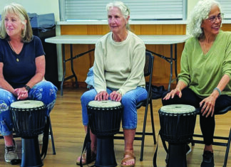 Finding the Groove Three women play hand drums during a community drum circle in Soquel