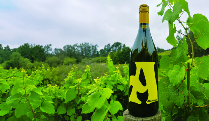 Ideal Nectar Bottle of Alfaro Family Vineyards A Estate Chardonnay stands among grapevines