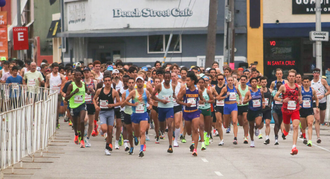 Runners cross the starting line during a past Wharf to Wharf race in Santa Cruz