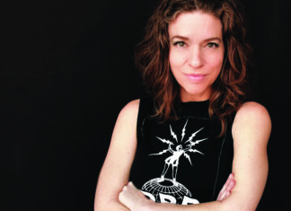 Blazing her own path Portrait of singer-songwriter Ani DiFranco against a black background.