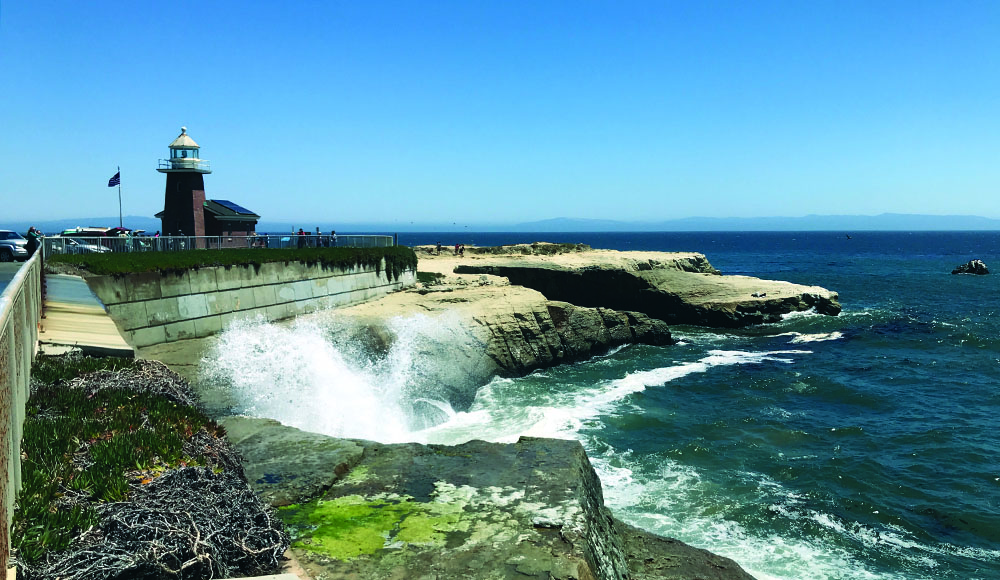 Waves break below the lighthouse and Santa Cruz Surfing Museum at Steamer Lane.