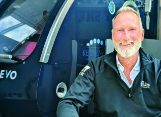 Under Pressure Dr. Jay Pennock sits beside a hyperbaric oxygen therapy chamber at Rejuvenate Medi-Spa and Wellness Center.