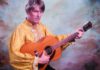 Things to do in Santa Cruz Stephen Malkmus holds an acoustic guitar while wearing a gold shirt