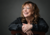 Volcanic Variations: Adela Najarro Santa Cruz poet Adela Najarro smiling for a studio portrait.