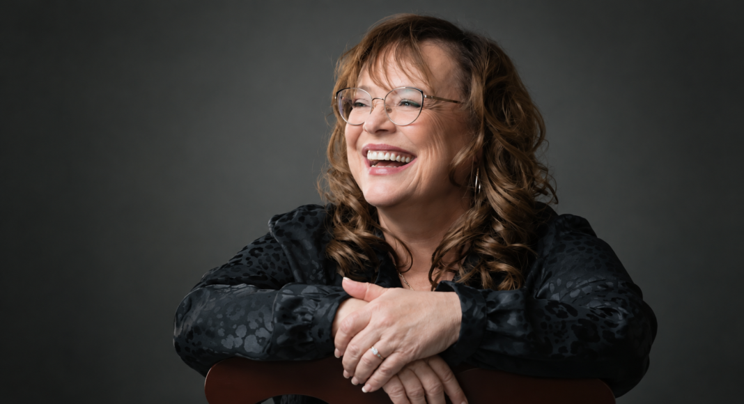 Santa Cruz poet Adela Najarro smiling for a studio portrait.