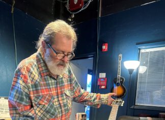 Guitar Greats Gather Saturday Santa Cruz Guitar Company founder Richard Hoover examines a handcrafted acoustic guitar.