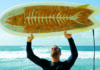 World Wide Waves Jack Johnson holds one of Taylor Lane’s Ciggy Boards made with thousands of discarded cigarette butts in Hawaiʻi.