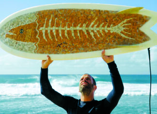 World Wide Waves Jack Johnson holds one of Taylor Lane’s Ciggy Boards made with thousands of discarded cigarette butts in Hawaiʻi.