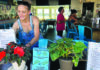 Slay Bar Bay Bar & Grill co-owner Brittny Beshore arranges plants and signs inside the Capitola Village bar and restaurant.