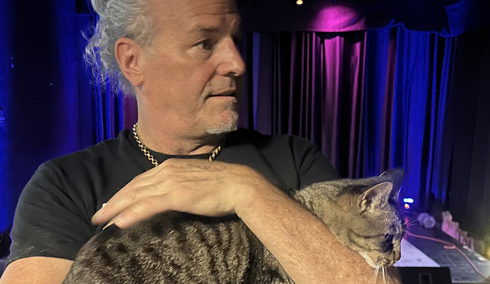 The Vessel founder Brent Adams holds a cat inside the former Santa Cruz music and community space.