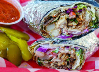 Wrap Star A Turkish döner wrap filled with meat, fries, lettuce, tomato, red cabbage and sauce, served with pickles and red sauce.