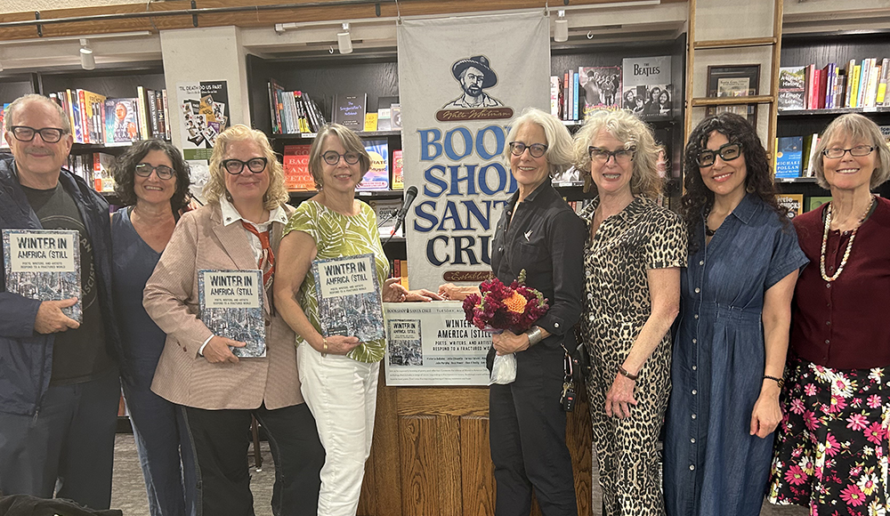Eight people pose at Bookshop Santa Cruz, several holding copies of Winter in America (Still. 