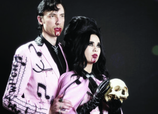 Things to do in Santa Cruz Twin Temple’s Alexandra and Zachary James pose in pink outfits with theatrical blood at their mouths, Alexandra holding a skull.
