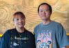 New Fire, Old Fears Nancy and Arun Sadkiriyasab stand together inside Lemongrass restaurant in Moss Landing, with gold artwork behind them.