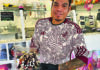Nice Dreams Hugo Moreles holds an ice cream dessert drizzled with chocolate sauce at Los Freseros Paleteria’s counter in Ben Lomond.