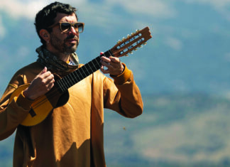 Things to do in Santa Cruz Facundo Salgado of Rumbo Tumba performing outdoors with a stringed instrument.