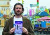 The Editor’s Desk Joshua Turek holds a poetry book at the Santa Cruz Beach Boardwalk