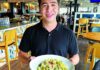 Main Beach Bites Luis Montoya holds a plate of pesto chicken penne inside Ideal Bar & Grill