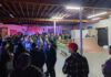 Grinding for a Great Cause A crowd gathers near a music stage and indoor skate ramps during a Grind the Cause benefit.