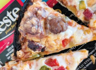 Rest in Pizza Alt text: Close-up of baked Mama Celeste pizza slices with sausage and diced peppers resting on Celeste packaging.