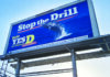 Fortifying the Blue Wall Blue billboard featuring a breaching whale reads “Stop the Drill” and urges a yes vote on Measure D by November 3.