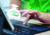 Pockets of Disruption A hand uses a laptop touchpad beneath an overlaid chatbot icon wearing a graduation cap.