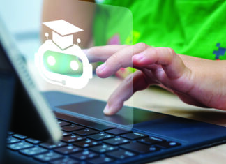 Pockets of Disruption A hand uses a laptop touchpad beneath an overlaid chatbot icon wearing a graduation cap.