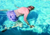 Underwater What? Ed Frey floats face-down with his arms extended in the sunlit pool at Simpkins Family Swim Center.
