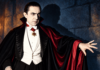 The Editor’s Desk Color illustration of Bela Lugosi as Dracula, wearing a black and crimson cape with one hand outstretched.