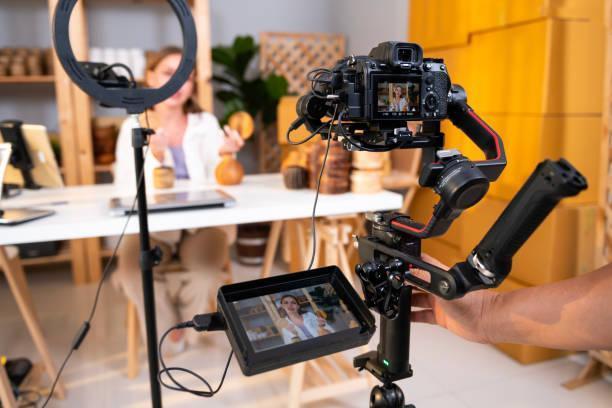 Woman entrepreneur live streaming craft products on a professional camera